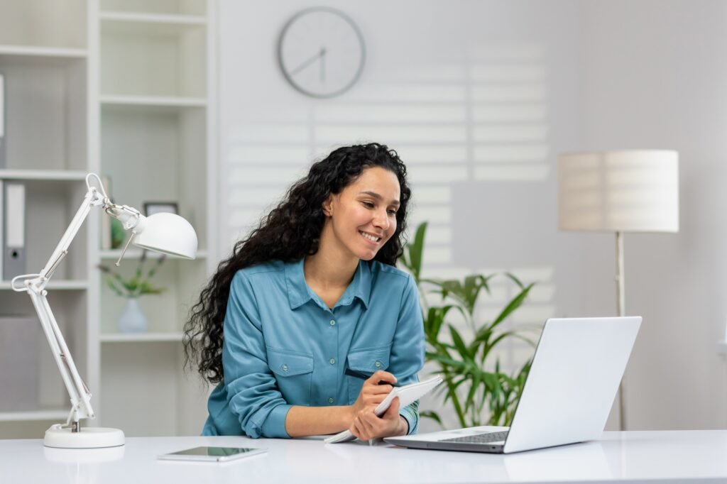 Young woman engaged in online training session with notebook